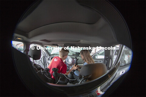 Nebraska students (from left) Brennan Darrah and Maddy Diedrichsen install a new computer screen ins