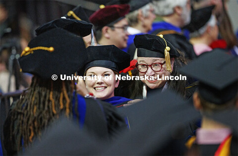 Jaclyn Marsh and her advisor Dawn Braithwaite pose for a photo as they walk along a congratulatory l