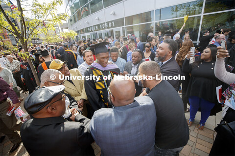 Friends, family and fellow Alpha Phi Alpha fraternity brothers form a circle around Davielle Phillip