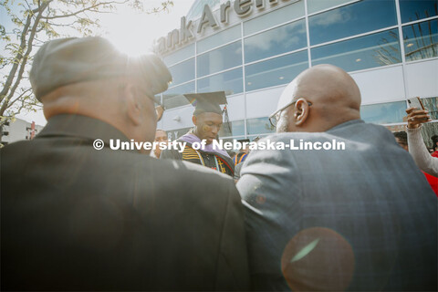 Friends, family and fellow Alpha Phi Alpha fraternity brothers form a circle around Davielle Phillip