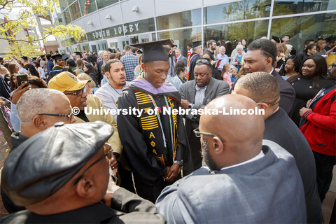 Friends, family and fellow Alpha Phi Alpha fraternity brothers form a circle around Davielle Phillip