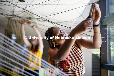 College of Architecture High School Workshop students use string to design in the atrium of the coll