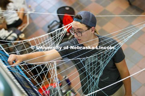 College of Architecture High School Workshop students use string to design in the atrium of the coll