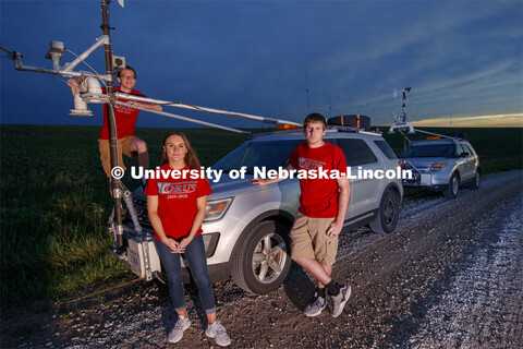 Students with the storm chaser car. Adam Houston, Professor of Earth and Atmospheric Sciences, led T