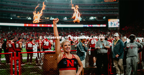 Twirler Carrigan Hurst twirling with batons lit on fire. Nebraska vs. Ohio State University football