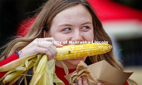 Samantha Simoneau tries an ear of grilled corn. Cornstock celebration and Homecoming Parade. October