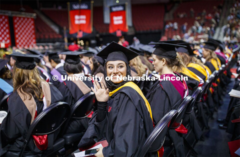 Sedighe Keynia waves to family and friends at the Graduate Commencement and Hooding at the Pinnacle 