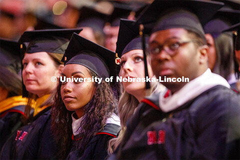 Briana Aldridge watches the greetings on the video screen at the start of the Graduate Commencement 