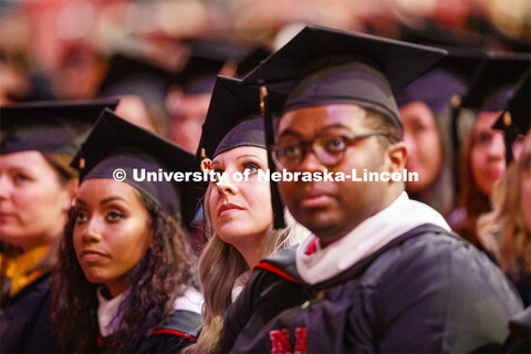 Sarah Arten watches the greetings on the video screen at the start of the Graduate Commencement and 