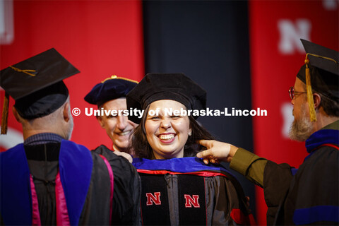 Raquel de Oliveira Rocha smiles as she is hooded at the Graduate Commencement and Hooding at the Pin