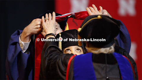 Brandi Bibins-Redburn has her eyes on the prize as her Doctor of Education hood is lowered over her 