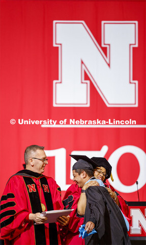 Hector de Jesus Palala Martinez is hugged by Marshall Marianna Banks as he receives his degree from 