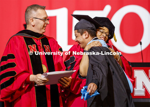 Hector de Jesus Palala Martinez is hugged by Marshall Marianna Banks as he receives his degree from 