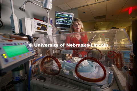 Erica Ryherd holds an acoustic meter while checking levels in the room of Ah'Mel, a patient at Nebra