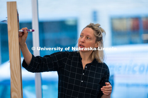 Assistant Professor Ash Smith writes on a marker board. Johnny Carson Center for Emerging Media Arts