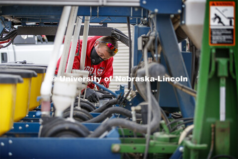 Josh Reznicek makes final adjustments to the planter before heading out into the field. James Schnab