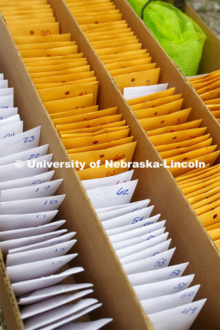 Packets of seeds are ready to plant. James Schnable corn research group plants at agronomy fields at