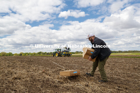 James Schnable positions boxes of seed packets in the field to speed up the planting process. James 