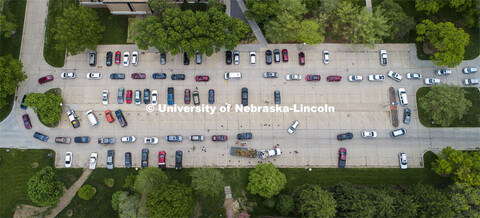 The line of cars for the flower give-away snaked through the parking lot east of the Dental College,