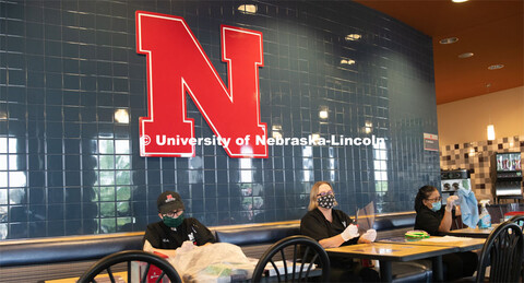 Dinning Services employees, Rochan Pinho, Janet Nichols and Dami Olsen, assemble face shields at Har