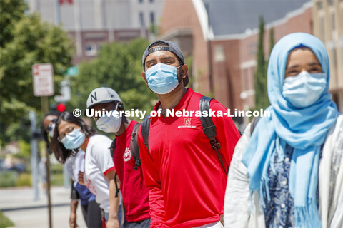 Students are masked up as they wait at the bus stop. Photo shoot of students wearing masks and pract