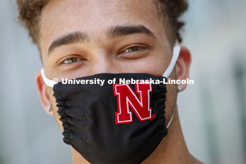 Hunter Johnson, a Junior in finance from Omaha wears a Husker mask. Photo shoot of students wearing 