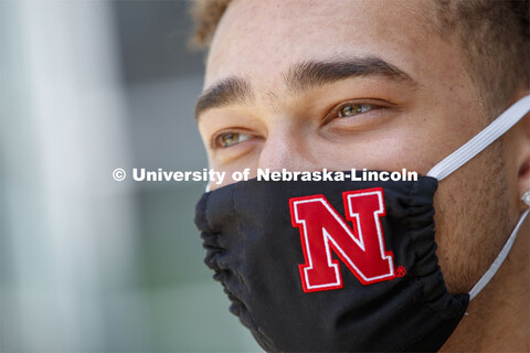 Hunter Johnson, a Junior in finance from Omaha wears a Husker mask. Photo shoot of students wearing 