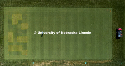 Michael Carlson, graduate student in agronomy, sprays the turf grass test plots on east campus.  Tur