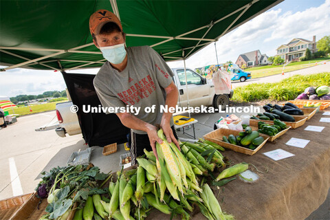 Vendors selling their produce at the Fallbrook Farmers Market in northwest Lincoln, Nebraska. July 2