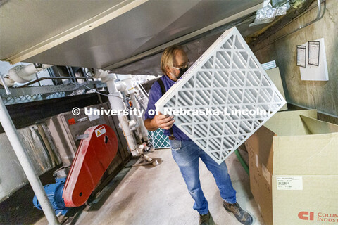 Lloyd Blessing, Zone Preventive Maintenance Associate, unpacks new air filters being installed in We