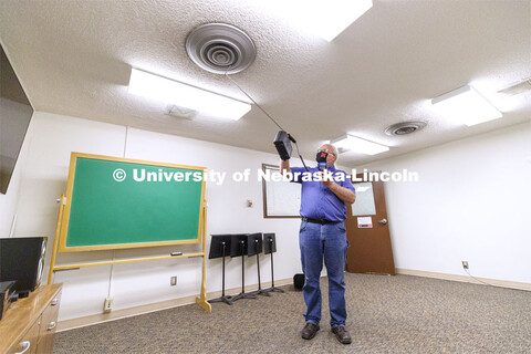 Dave Tyler, Control Systems Tech, uses a hot wire anemometer to measure air coming from a vent in a 