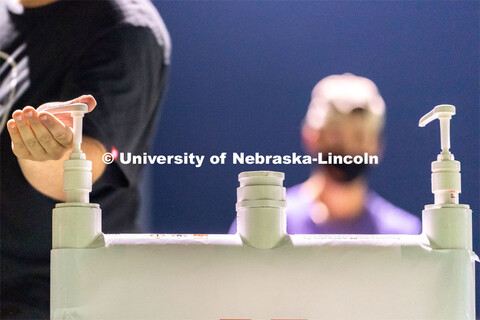 A student makes use of a hand sanitizing station while leaving Mabel Lee Fields at the conclusion of