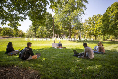 Arden Eli Hill teaches her science fiction course in the shade outside Andrews Hall Monday. City Cam