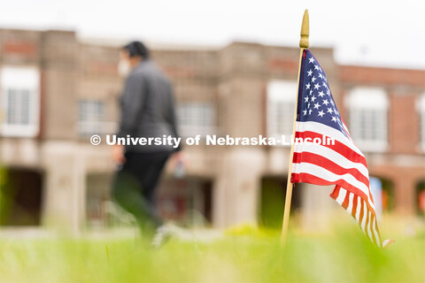 A student walks past an American flag placed in the Donald and Lorena Meier Commons on Thursday, Sep