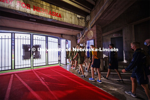 Cadets file into Memorial Stadium at 5:45 a.m. to begin the step run. UNL ROTC cadets and Lincoln fi