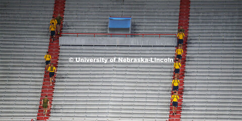 Marine and Navy cadets run the west stadium steps. UNL ROTC cadets and Lincoln first responders run 