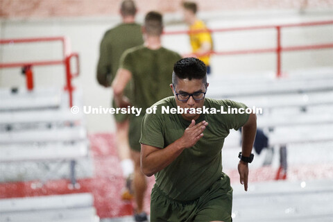 Midshipman Enriquez Carlos runs the west stadium steps. UNL ROTC cadets and Lincoln first responders