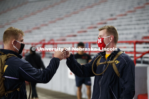 Midshipmen Christian New, left, and Chris Haidvogel fist bump after completing the run. UNL ROTC cad