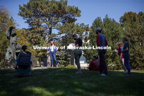 Professor, Anna Henson talks with her students as the Principles of Interactivity class takes an art