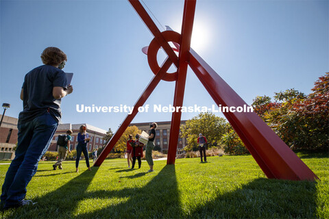 Professor, Anna Henson talks with her students as the Principles of Interactivity class takes an art