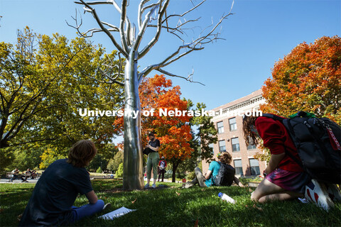 Students in the Principles of Interactivity class surround Breach, a sculpture by Roxy Paine, during