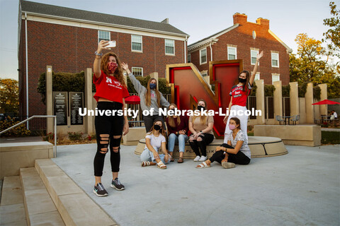 A group of Delta Delta Delta sorority sisters do a group photo in front of the “N” sculpture at 