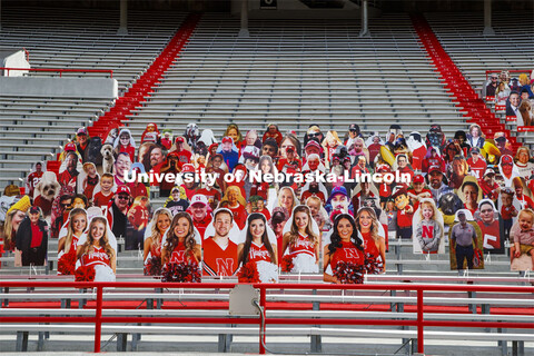 Cardboard cutouts of fans fill the stands in Memorial Stadium. Cornhusker Marching Band, Cheer Squad