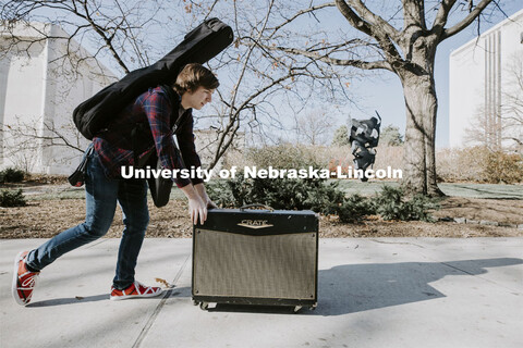 Brock Godown, a freshman from Geneva, rolls his amplifier back to his residence hall following a mus