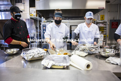 Professor Ajai Ammachathram’s, left, watches as his Catering Management students prepare a wedding