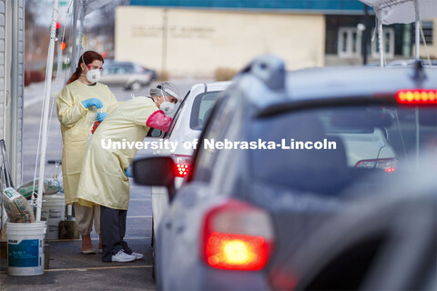 Katie Hibberd, RRT, swabs a drive-up participant at the testing pod. Participants in COVID testing a