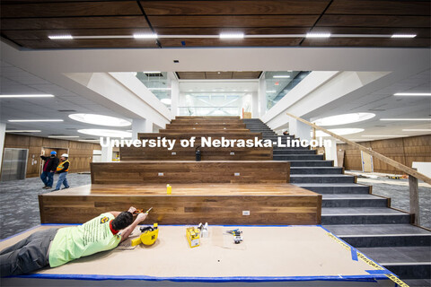 Workers wire electrical outlets into the Learning Stairs. The tiered area leading to the second floo