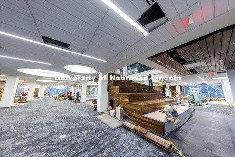 Workers wire electrical outlets into the Learning Stairs. The tiered area leading to the second floo