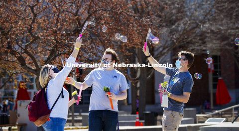 Samantha Moore, William Roarty and Jace Armstrong let the wind do the work as they blow bubbles outs