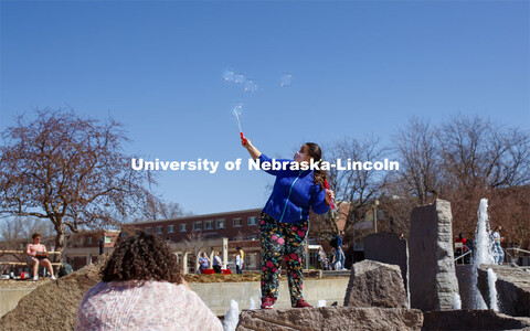 Julia Nogueira Duarte Campos blows bubbles while her friend takes a photo. Students have fun at the 